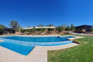 a swimming pool with blue water in a yard at Cabañas Pachamama Casablanca in Casablanca