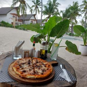 a pizza sitting on top of a table at Anna's House in Pingwe