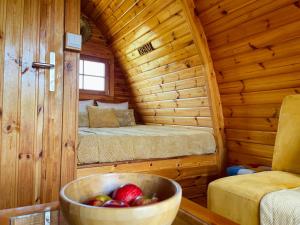 a wooden cabin with a bowl of fruit in it at The Gold Pod, relax and enjoy on a Glamping house in Corredoura