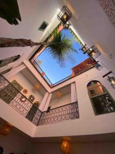 a room with a ceiling with a palm tree in it at Riad ABADA Medina Marrakech (Sidi Mimoun) in Marrakech