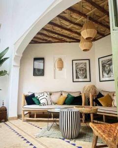 a living room with a couch and a table at Riad ABADA Medina Marrakech (Sidi Mimoun) in Marrakesh