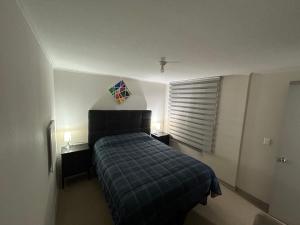 a bedroom with a bed and a window with a kite at Cómodo Dpto en Curicó in Curicó