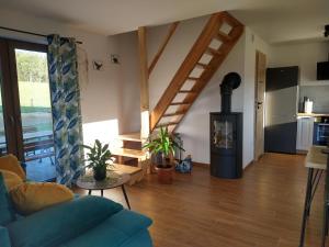 a living room with a blue couch and a wood stove at Domek Rodakówka in Krempna