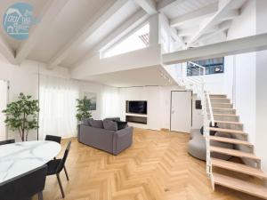a living room with a staircase and a couch at Tarabochia 8 Tirabora Short Rent in Trieste