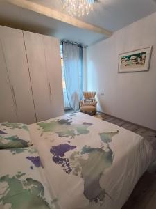 um quarto com uma cama grande e uma cadeira em La Casina Pallacorda em Prato