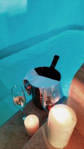 a bottle of wine in a bucket next to a pool at Dimore di Gio' Luxury Private Wellness Spa in Ostuni
