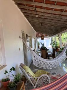 a porch with a hammock in a house at Casa com 4 quartos e área externa com jardim in São Raimundo Nonato