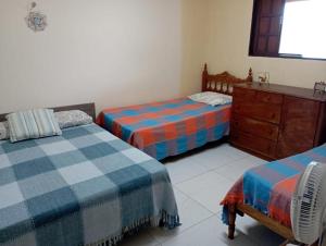 Ένα ή περισσότερα κρεβάτια σε δωμάτιο στο Cantinho no Paraíso