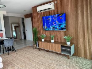 a living room with a fish tank on the wall at 4B - Centríco Divertido FIT 4BR in Panama City