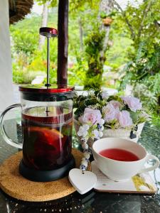 a cup of tea and a cup of coffee on a table at Villa La Fortuna Altos del Maria in Filipina