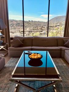 a living room with a bowl of oranges on a glass table at Villa Hirondelles 35 in Cavalaire-sur-Mer