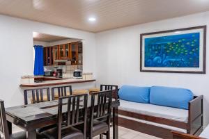 a dining room with a table and a couch at Paradise Breeze 2Bdr near Quepos Manuel Antonio in Quepos
