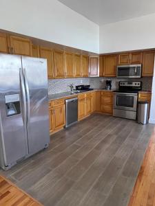 a kitchen with stainless steel appliances and wooden cabinets at Catappa Condos in Morne Rouge