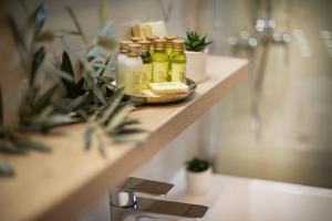 a shelf with several bottles of oils on it at Villa Beller New in Ičići +37 photos