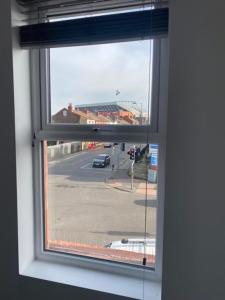 an open window with a view of a street at The Glenbuck Hotel Anfield in Liverpool