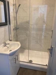 a bathroom with a shower and a sink at The Glenbuck Hotel Anfield in Liverpool