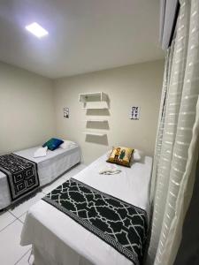 a room with two beds and a staircase in it at Temporada CG - Campina Apart-Hotel in Campina Grande