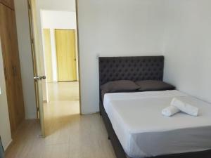 a bedroom with two beds and a door to a hallway at El Encanto casa de descanso in Rivera
