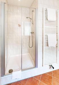 a bathroom with a shower with a tub at Hotel Quellenhof in Bad Breisig