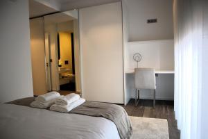 a bedroom with a bed with towels on it at Seaside XXI-10, By OP in Funchal +18 photos