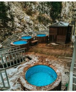 a large pool of water with tables and a building at Room in the house, with mountain views and squirrels in the yard in Almaty