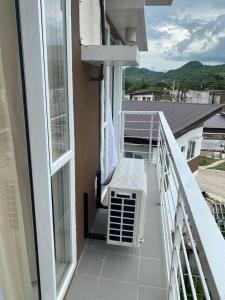 a balcony with a white bench on a building at Modena TownSquare in Minglanilla in Minglanilla