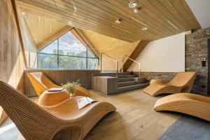 a living room with wooden furniture and a large window at Rezydencja OWCA NA SZLAKU in Zakopane