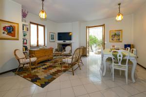 a living room with a table and chairs and a tv at Torlonia: Due matrimoniali e bagno in Luco neʼ Marsi