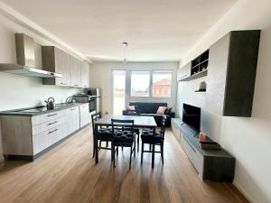 a kitchen and dining room with a table and chairs at Suite Art Padova Centro in Padova