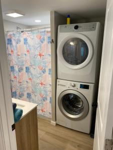 a washing machine in a laundry room with a shower curtain at ON Deck few Blocks Fr BEACH 6 BR/4Ba Newly Reno in Myrtle Beach