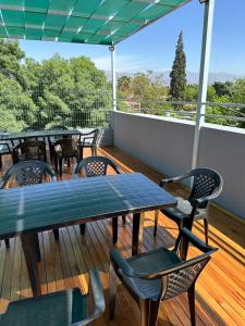 a patio with tables and chairs on a deck at Departamento en capital Mendoza 2 ubicadisimo estacionamiento incluido in Mendoza