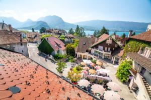 an aerial view of a town with buildings and umbrellas at Cabana & Au Coeur du Village in Talloires +12 photos