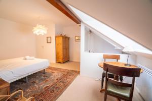 a bedroom with a bed and a table and a desk at Cabana & Au Coeur du Village in Talloires