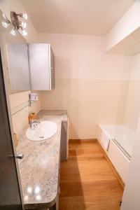 a bathroom with a sink and a bath tub at Cabana & Au Coeur du Village in Talloires