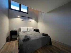 a bedroom with a bed and a window on the wall at VLC Apart in Valencia