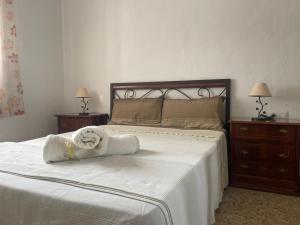 a bedroom with a bed with a towel on it at Casa LuLa in Villafranca de Córdoba