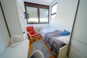 a small room with a bed and a chair at MiRa in Užice