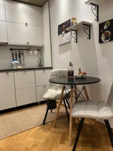 a small kitchen with a table and two chairs at Apartment D-22 in Belgrade