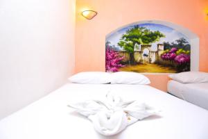 Postel nebo postele na pokoji v ubytování Hotel Hacienda Cancun