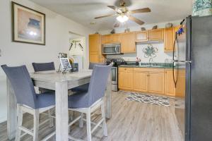 a kitchen with a table and chairs and a refrigerator at Cozy Indiana Home with Deck, Charcoal Grill and Yard! in Marion