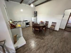 a kitchen and dining room with a table and chairs at Puesta del Sol in Campo Quijano