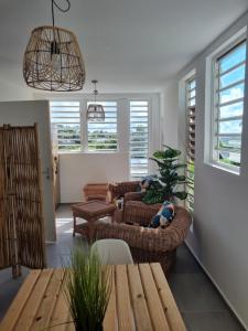 a living room with two couches and a table at Logement de roots evasions in Petit-Bourg
