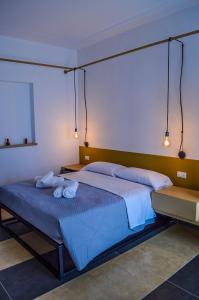 a bedroom with a large bed with two towels on it at Scavi 32 in Ercolano