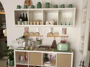 a shelf filled with dishes and bottles of wine at Villa Wolf Castle - vanjski grijani bazen in Lopatinec