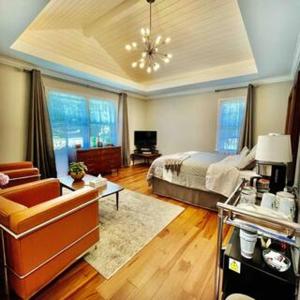 a bedroom with a bed and a couch and a table at Pittsford Garden Retreat in Pittsford