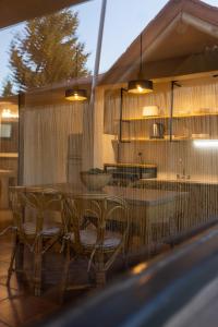 a dining table and chairs on a patio with lights at Cabañas Rio Soñado in Valle Grande
