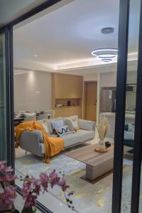 a living room with a couch and a table at GTC Luxury Top Floor Apartment, Nairobi in Nairobi