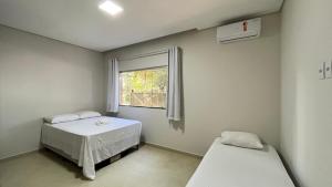 Una habitación de hospital con dos camas y una ventana. en Casa Sossego Trancoso, en Trancoso