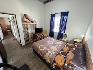 1 dormitorio con cama, escritorio y ventana en Puesta del Sol en Salta