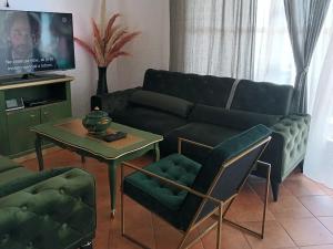 a living room with a couch and a table at Villa Wolf Castle - vanjski grijani bazen in Lopatinec